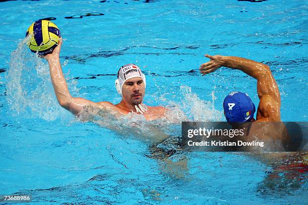 Florin Bonca of Romania attepts to stop the pass from Peter Biros of Hungary during the Men's Preliminary Round Group D Water Polo match between...