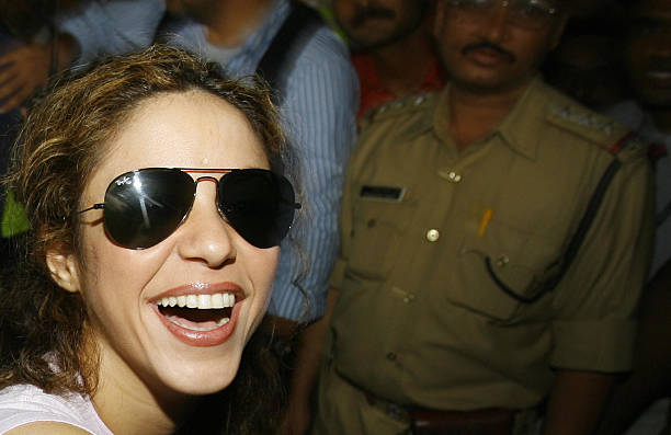 Colombian singer Shakira smiles as she greets unseen well-wishers as she leaves the arrivals hall of Chattrapati Shivaji International Airport in...