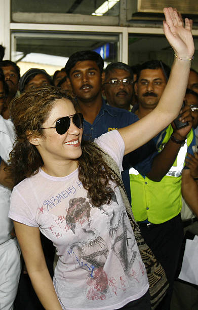 Colombian singer Shakira waves to unseen well-wishers as she leaves the arrivals hall of Chattrapati Shivaji International Airport in Mumbai, 24...