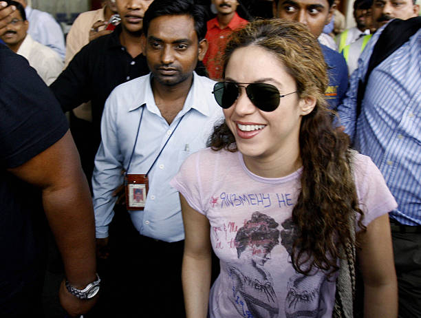 Colombian singer Shakira walks with officials as she leaves the arrivals hall of Chattrapati Shivaji International Airport in Mumbai, 24 March 2007....