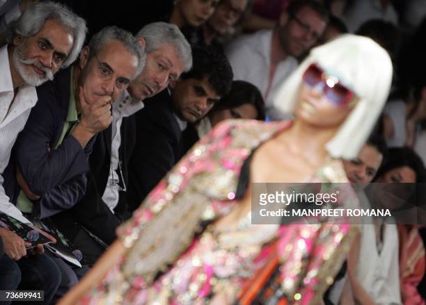 President of the Paris Fashion Week Didier Grumbach watches a model display a creation by Indian designer Manish Arora during the Wills India Fashion...