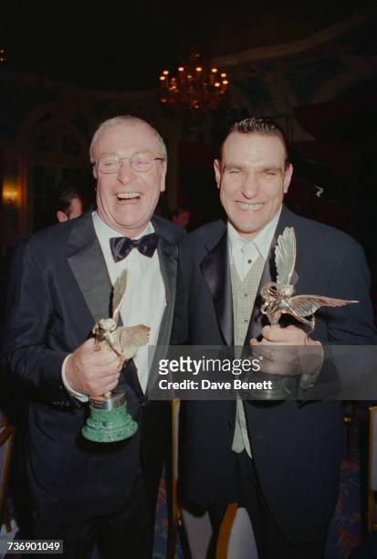 Michael Caine and Vinnie Jones holding awards at the Evening Standard Film Awards at the Savoy Hotel, London, 7th February 1999.