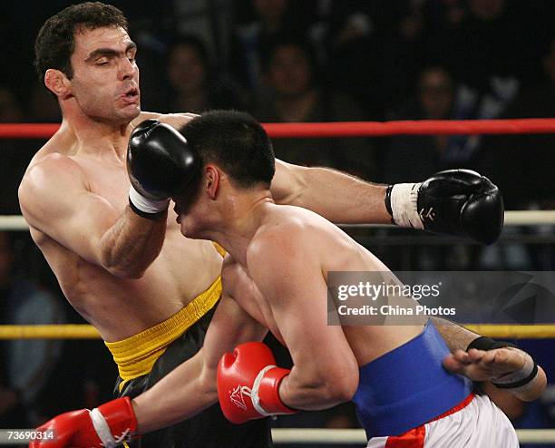 Huang Lei of China fights against Mohammadreza Jafari of Iran, during the 85kg category semifinal of the Second International Chinese Kung Fu...