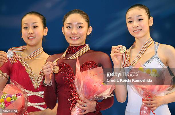 Silver medalist Mao Asada of Japan, Gold medalist Miki Ando of Japan and Bronze medalist Yu-Na KIM of South Korea pose after the medals ceremony...