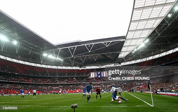 London, UNITED KINGDOM: Italy's Raffaele De Martino takes the ball away from England's Leroy Lita at the new Wembley stadium in London, 24 March...