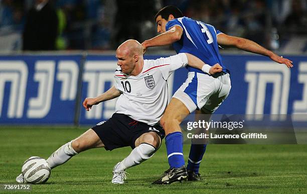 Andy Johnson of England is challenged byTal Ben Haim of Israel during the Euro 2008 Qualifying match between Israel and England at the Ramat Gan...