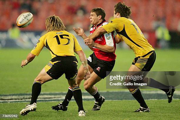 Cory Jane and Conrad Smith pf the Hurricanes tackle Jannie Boshoff of the Lions during the Super 14 match between the Lions and Hurricanes at Ellis...