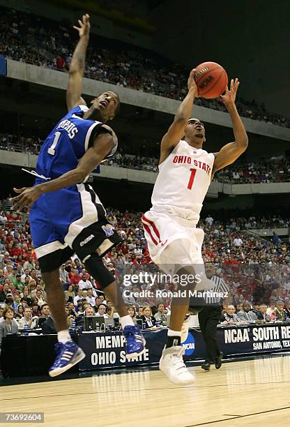 Mike Conley Jr. #1 of the Ohio State Buckeyes drives for a shot attempt against Willie Kemp of the Memphis Tigers during the south regional final of...