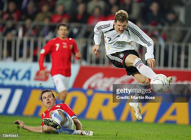 Bastian Schweinsteiger of Germany goes past the challenge of Tomas Galasek of Czech Republic and during the Euro2008 Qualifier match between Czech...