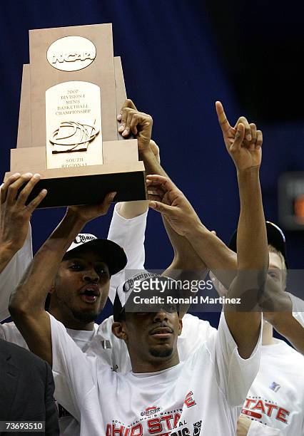 South region MVP Mike Conley Jr. #1 of the Ohio State Buckeyes celebrate with the south region trophy after their 92-76 win against the Memphis...