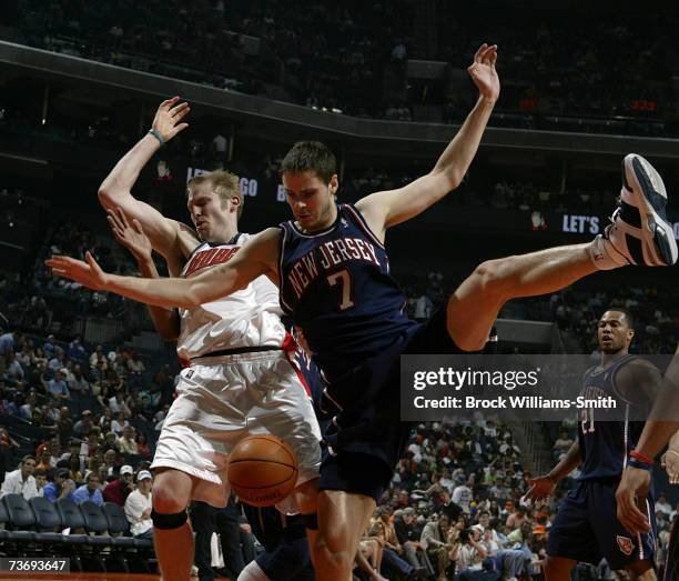 Bostjan Nachbar of the New Jersey Nets and Jake Voskuhl of the Charlotte Bobcats try for the rebound on March 24, 2007 at the Charlotte Bobcats Arena...