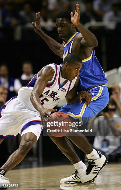 Mario Chalmers of the Kansas Jayhawks drives the ball against Alfred Aboya of the UCLA Bruins during the west regional final of the NCAA Men's...