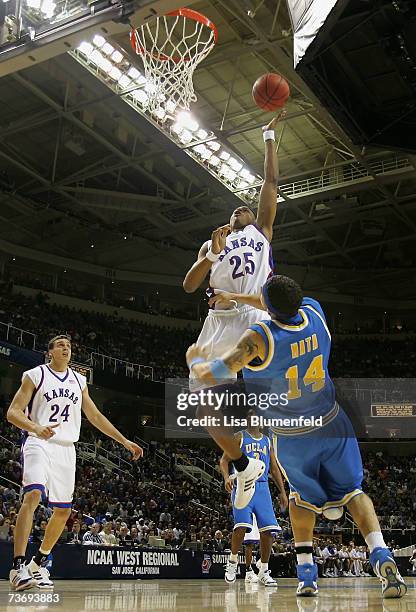 Brandon Rush of the Kansas Jayhawks lays up a shot over Lorenzo Mata of the UCLA Bruins during the west regional final of the NCAA Men's Basketball...