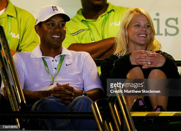 Golfer Tiger Woods and wife Elin Woods watch the night session at day four at the 2007 Sony Ericsson Open at the Tennis Center at Crandon Park on...
