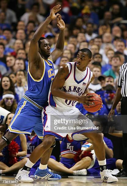 Darrell Arthur of the Kansas Jayhawks handles the ball under pressure from Luc Richard Mbah a Moute of the UCLA Bruins during the west regional final...