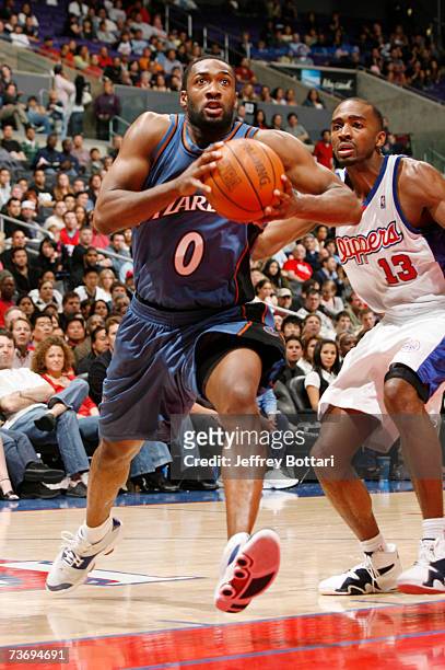 Gilbert Arenas of the Washington Wizards drives to the hoop against Quinton Ross of the Los Angeles Clippers on March 24, 2007 at Staples Center in...