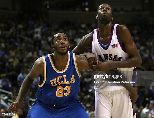 Luc Richard Mbah a Moute of the UCLA Bruins blocks out Julian Wright of the Kansas Jayhawks during a free throw shot in the west regional final of...