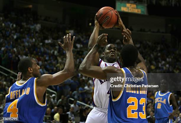 Sherron Collins of the Kansas Jayhawks attempts a shot against Luc Richard Mbah a Moute of the UCLA Bruins during the west regional final of the NCAA...