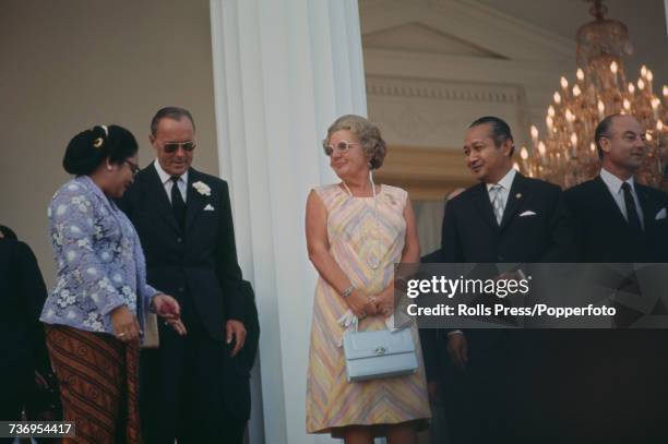 Queen Juliana of the Netherlands , pictured in centre with her husband Prince Bernhard of Lippe-Biesterfeld , are welcomed by President Suharto of...