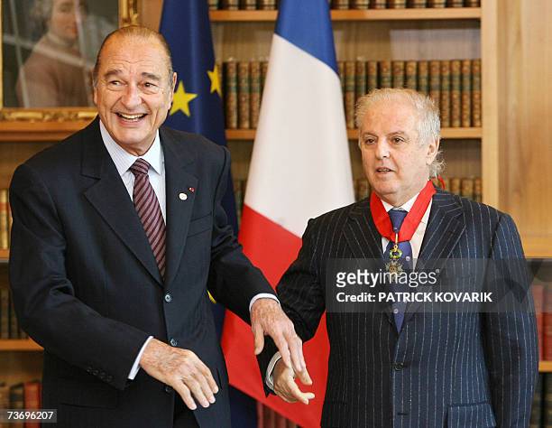 French President Jacques Chirac poses with Argentinian-born Israeli conductor Daniel Barenboim after awarding him with the insigna of commander of...