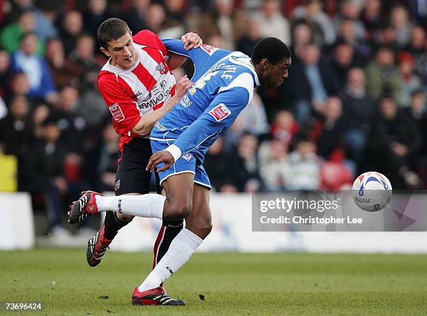 Craig Rocastle of Oldham battles with John Mousinho of Brentford during the Coca-Cola League One match between Brentford and Oldham Athletic at...