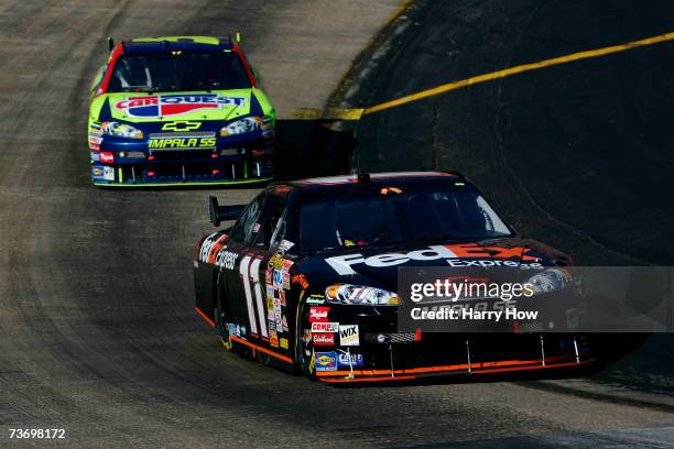 Denny Hamlin, driver of the FedEx Express Chevrolet, leads Kyle Busch, driver of the Carquest Chevrolet, during the NASCAR Nextel Cup Series Food...