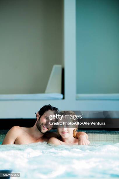 couple relaxing together in hot tub - hot wife stockfoto's en -beelden