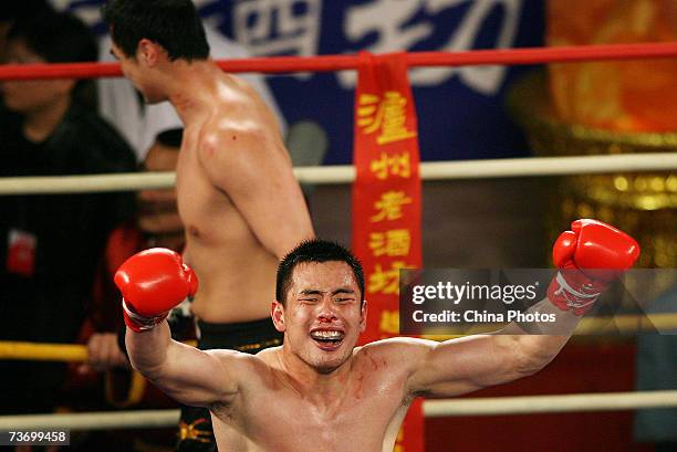 Huang Lei of China celebrates after he won the open weight division of the Second International Chinese Kung Fu Competition on March 25, 2007 in...