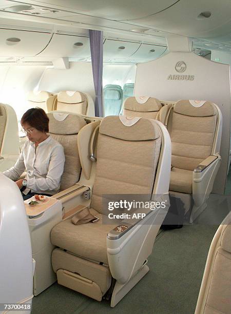 Journalist sits in the business class section of the world's largest civilian aircraft, the Airbus A380 superjumbo, this one operated by German...