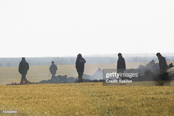 Military personnel investigate the crash site and debris of two MIG-29 fighter jets on March 21, 2007 in Millerovo, Rostov region, in southern...