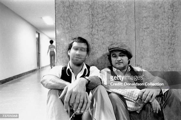 Actors Chevy Chase and John Belushi take a break in the NBC Studios in 1976 in New York.