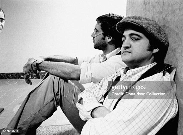 Actors Chevy Chase and John Belushi take a break in the NBC Studios in 1976 in New York.