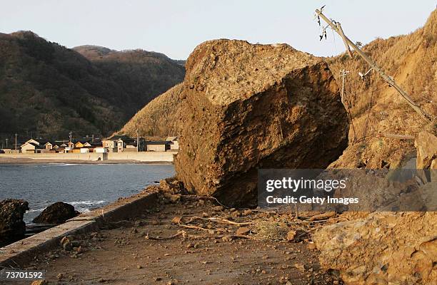 An enormous stone on a road that fell from a cliff due to an earthquake that struck off the west coast of Japan's Largest Island Honshu, on March 26,...