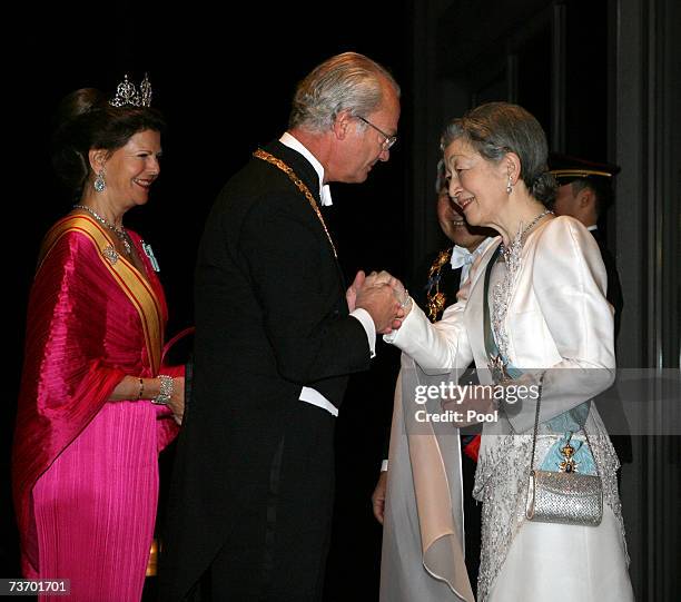 King Carl XVI Gustaf of Sweden greets Empress Michiko of Japan , as Queen Silvia of Sweden and Emperor Akihito of Japan look on prior to their dinner...