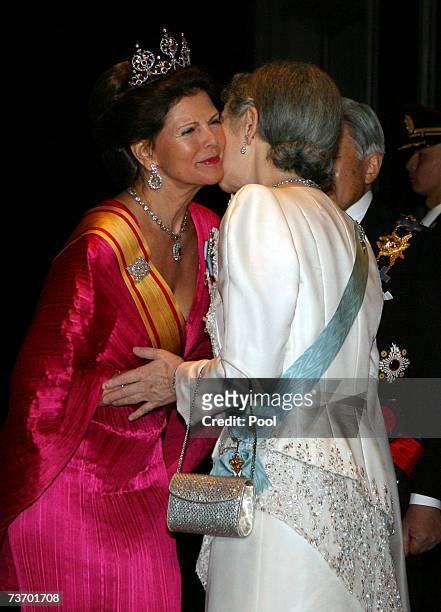 Queen Silvia of Sweden is greeted by Empress Michiko of Japan on arriving for dinner at the Imperial Palace on March 26, 2007 in Tokyo, Japan. The...