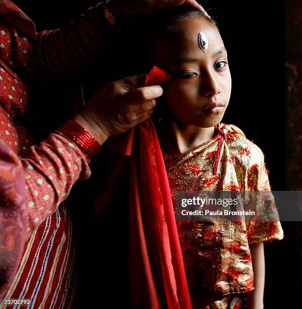 Kumari Devi Sajani Shakya gets ready for puja with the help of her mother, Rukmani in a special room, March 24, 2007 in Bhaktapur, Nepal. As a royal...