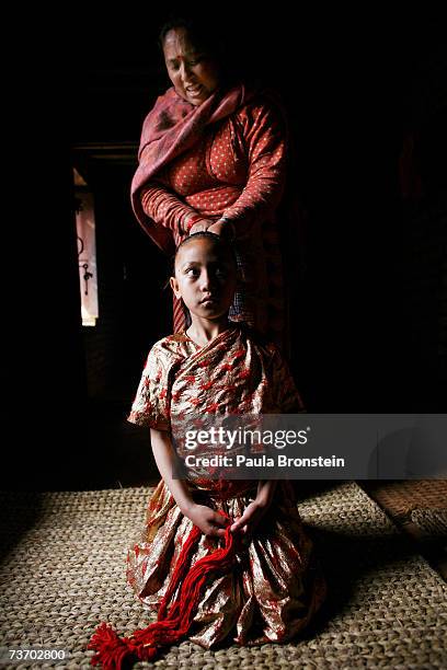 Kumari Devi Sajani Shakya gets ready for puja with the help of her mother, Rukmani in a special room, March 24, 2007 in Bhaktapur, Nepal. As a royal...