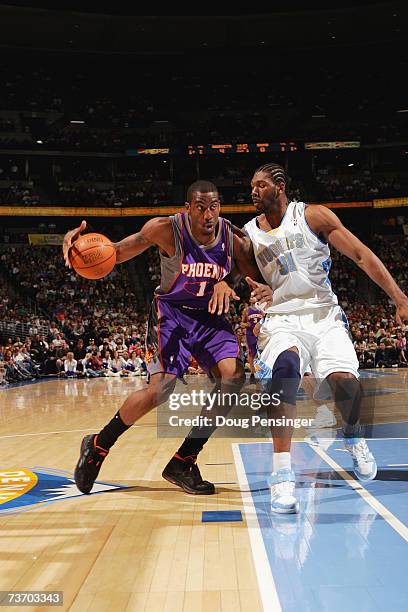 Amare Stoudemire of the Phoenix Suns is defended by Nen? #31 of the Denver Nuggets during the game on March 17, 2007 at the Pepsi Center in Denver,...