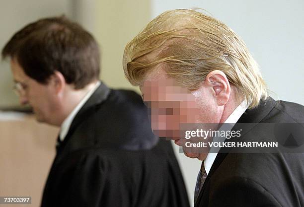 Defendant Uwe D. Is accompanied by his lawyer Benno Schneidermeyer as he arrives for his trial 26 March 2007 at court in Essen, western Germany. The...