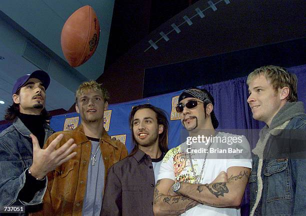 Pop group The Backstreet Boys play around with a football during a press conference for performers in the 2001 Super Bowl XXXV pre-game show at...