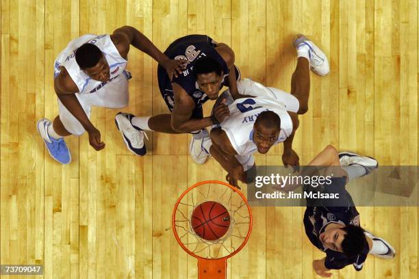 Deon Thompson and Reyshawn Terry of the University of North Carolina Tar Heels fight for position against Patrick Ewing Jr. #33 and Jeremiah Rivers...