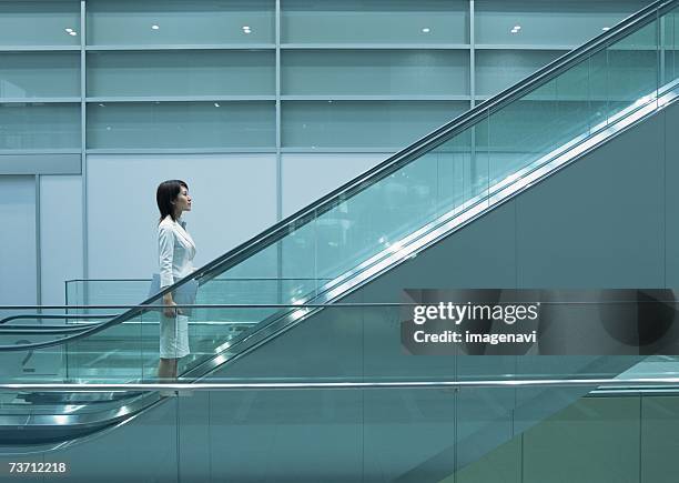 image of business woman - escalator side view stock pictures, royalty-free photos & images