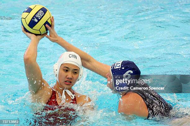 Anna Zubkova of Kazakhstan stops the pass from Ma Huanhuan of China in the Women's Final Round 13th-14th place Water Polo match between China and...