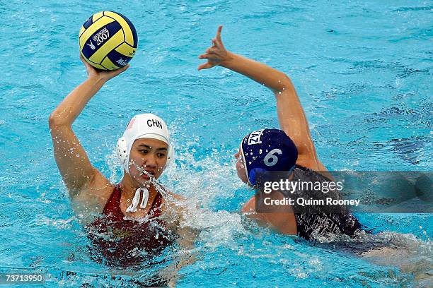 Anna Zubkova of Kazakhstan stops the pass from Ma Huanhuan of China in the Women's Final Round 13th-14th place Water Polo match between China and...