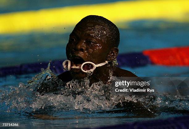 Gibrilla Bamba of Sierra Leone loses his goggles in the Men's 50m Breaststroke heats during the XII FINA World Championships at the Rod Laver Arena...