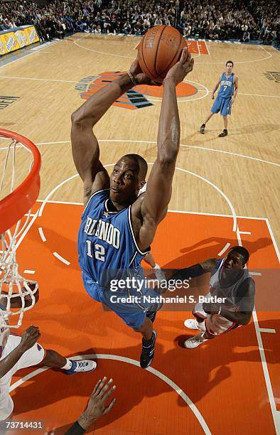 Dwight Howard of the Orlando Magic dunks against Nate Robinson of the New York Knicks on March 26, 2007 at Madison Square Garden in New York City....