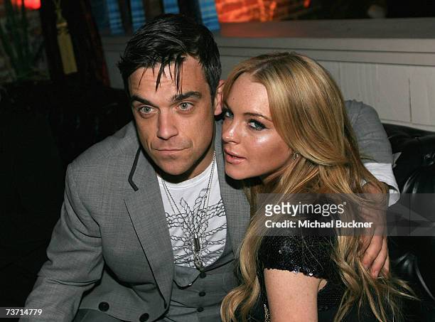 Singer Robbie Williams and actress Lindsay Lohan attend the after party for the premiere screening of Showtime's "The Tudors" at Les Deux on March...