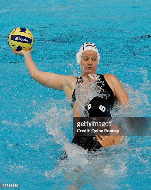Anett Timea Gyore of Hungary gets a pass away under pressure from Katrina Monton of Canada during the Women's Quarter Final Round Water Polo match...