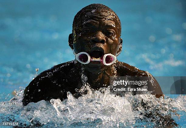 Gibrilla Bamba of Sierra Leone loses his goggles as he swims in the Men's 50m Breaststroke heats during the XII FINA World Championships at the Rod...