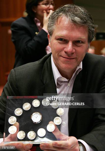 Dutch Finance Minister Wouter Bos holds 27 March 2007 before an Economy and Finance Council meeting at EU headquarters in Brussels a new euro coin...